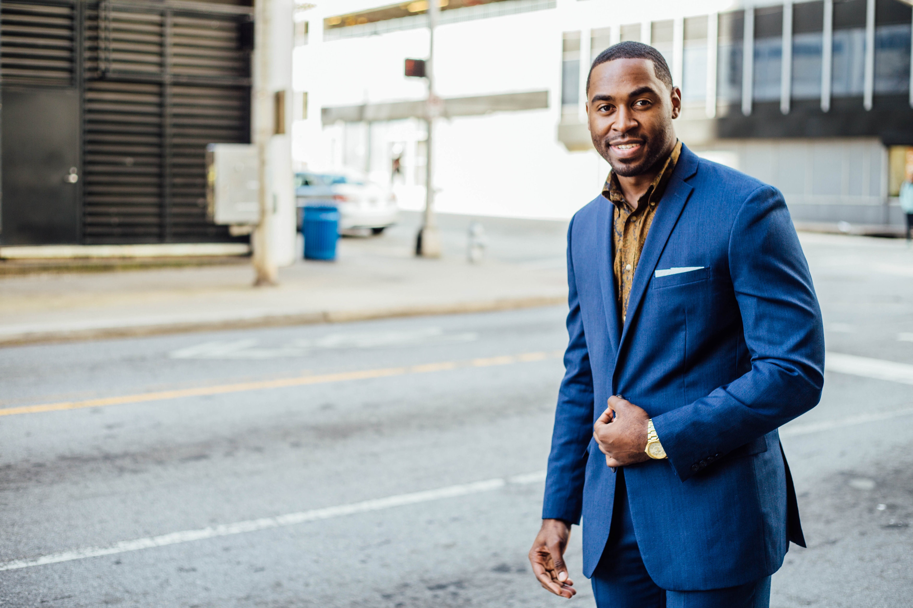 man in blue suit walking down street - first impression