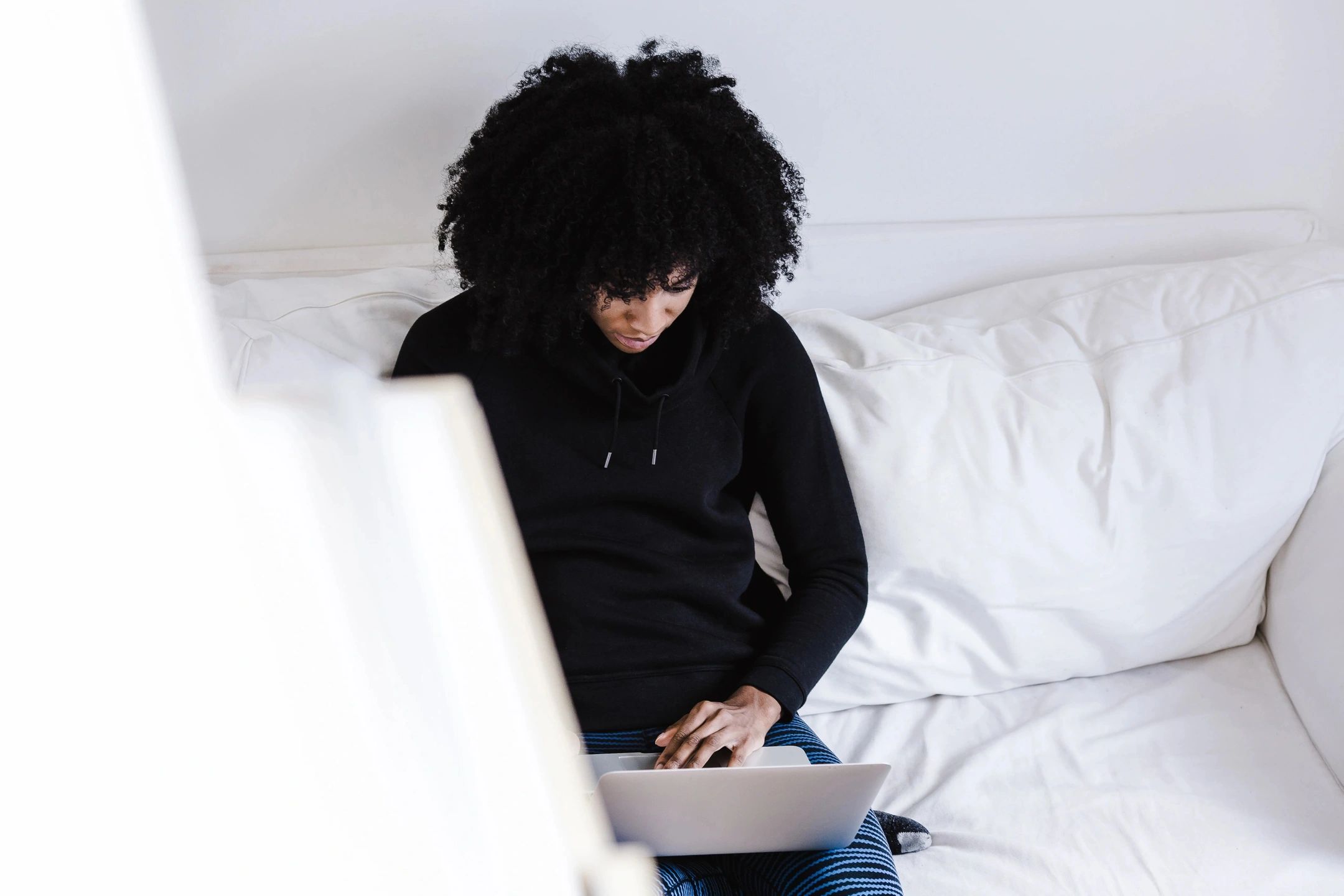 A woman working on her laptop from home.